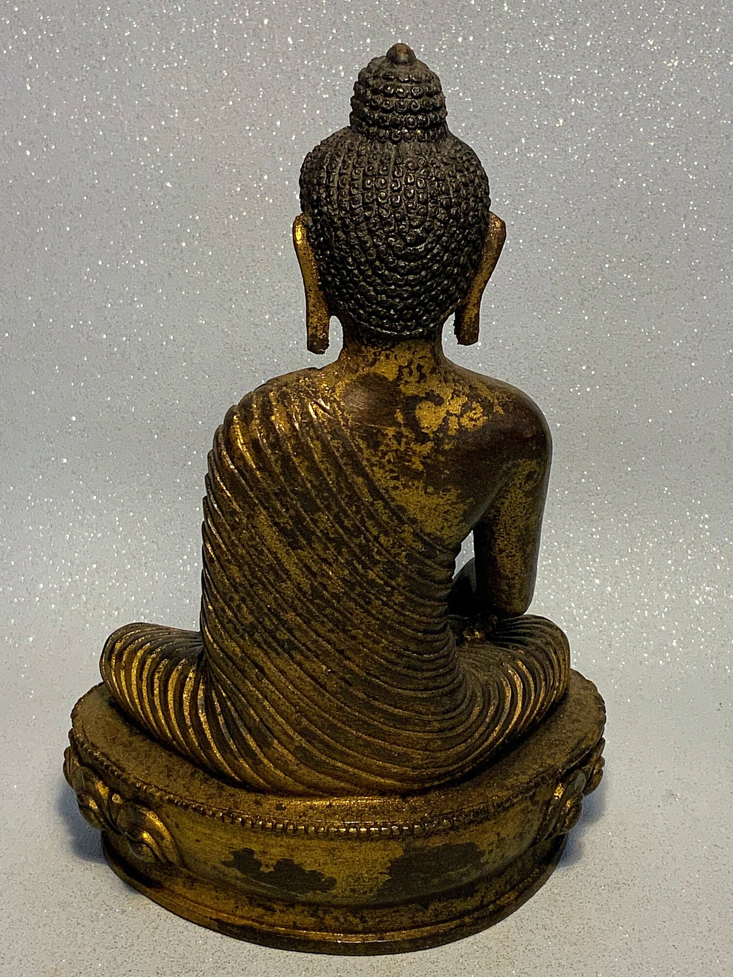 An antique bronze and gilt Buddha statue
