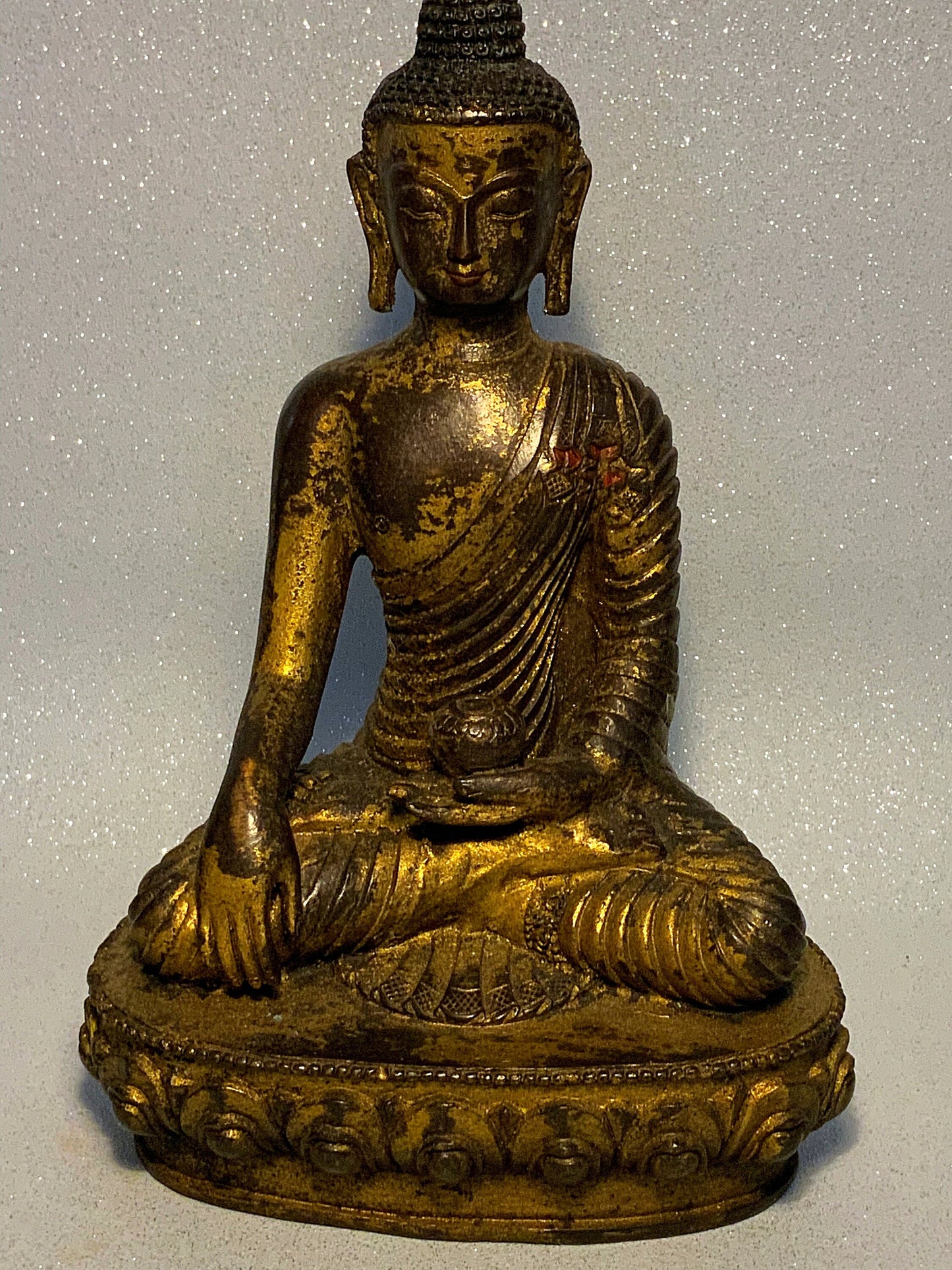 An antique bronze and gilt Buddha statue