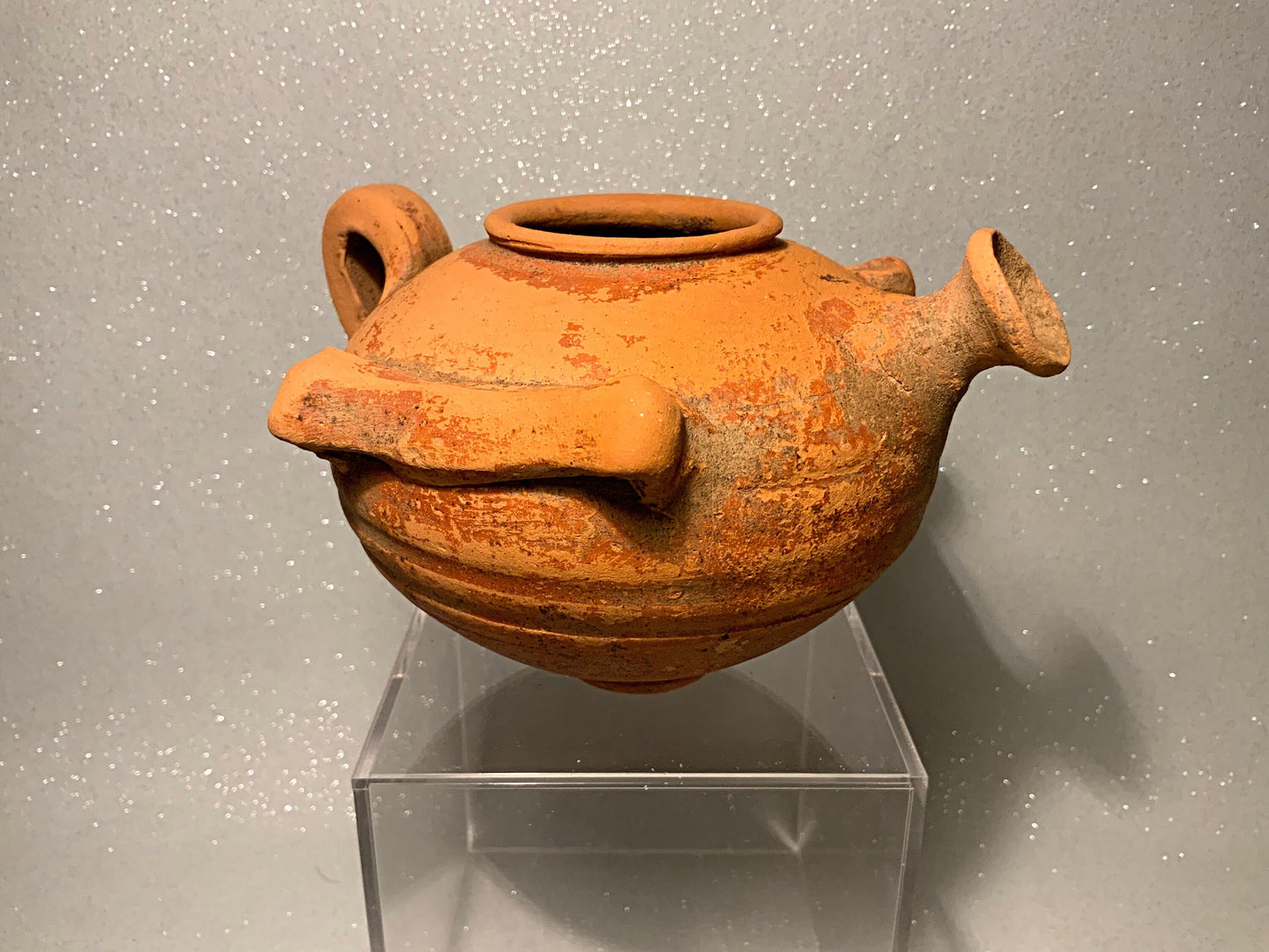 An ancient terracotta pot with spout