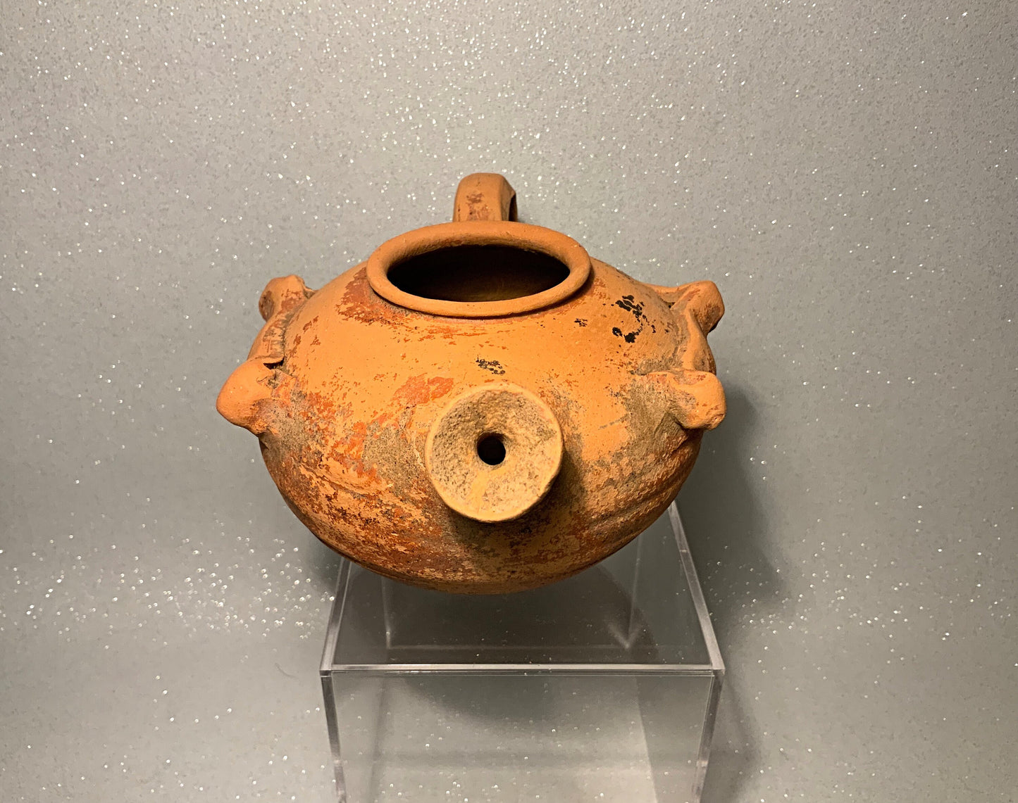 An ancient terracotta pot with spout