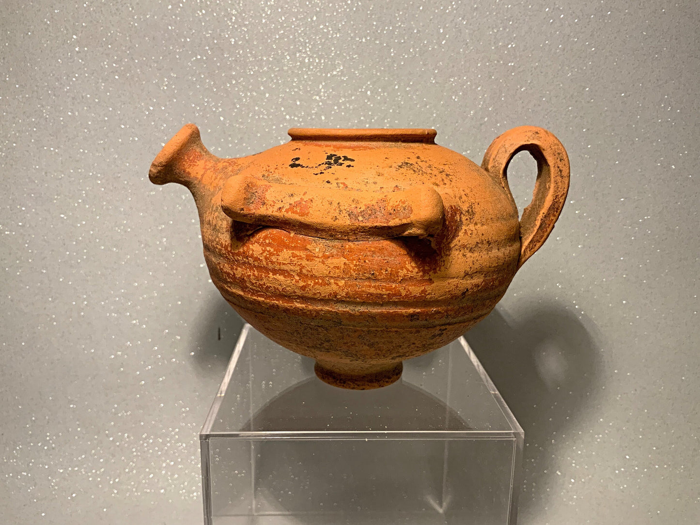 An ancient terracotta pot with spout