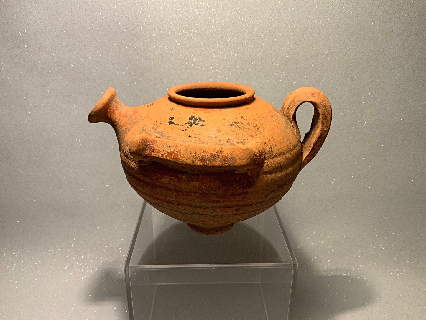 An ancient terracotta pot with spout
