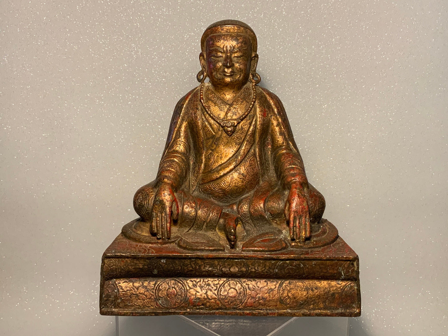 A antique bronze and gilt Buddha statue