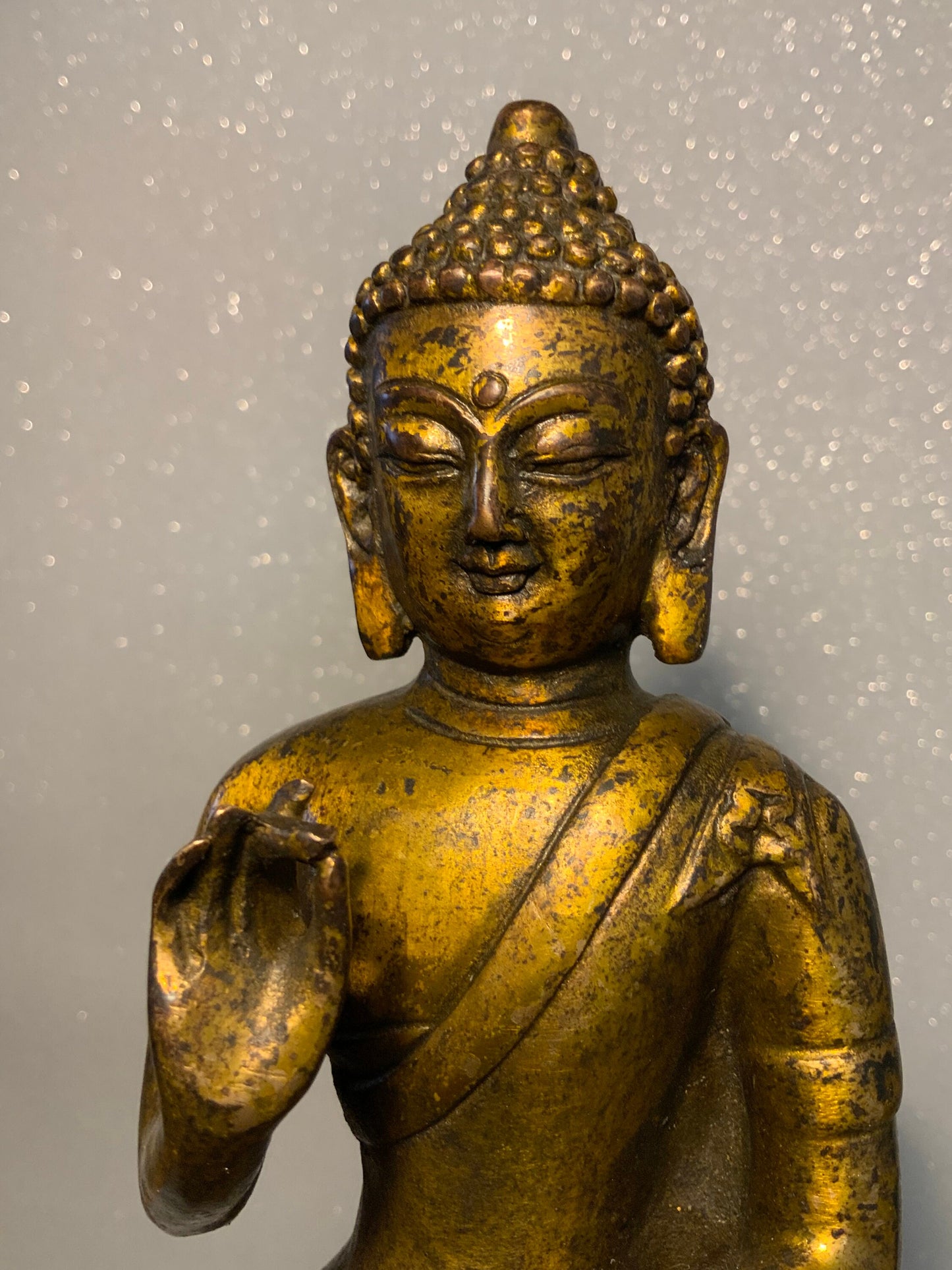 An antique bronze and gilt Buddha statue
