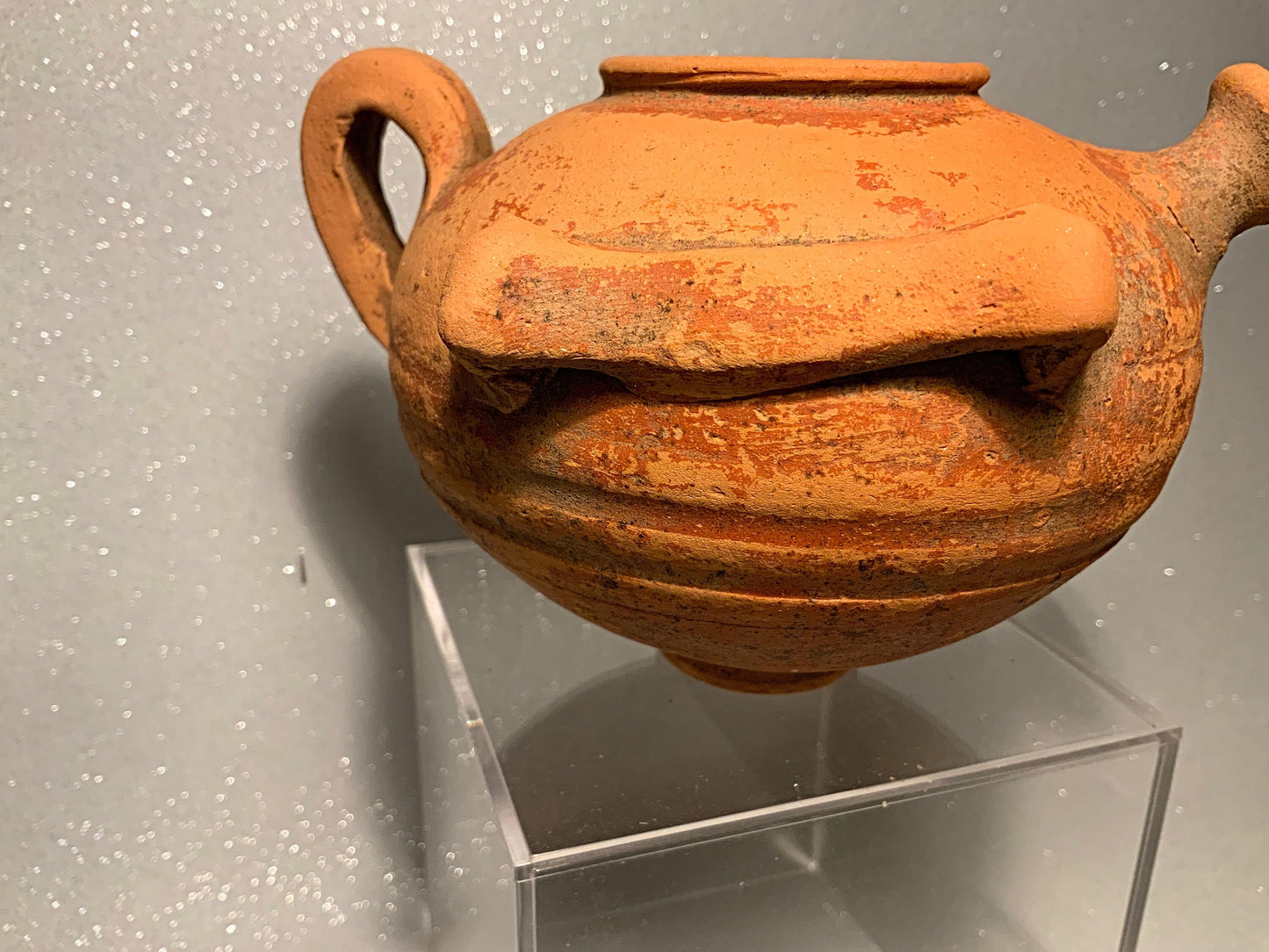 An ancient terracotta pot with spout