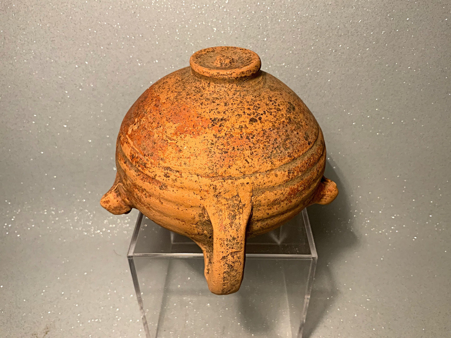 An ancient terracotta pot with spout