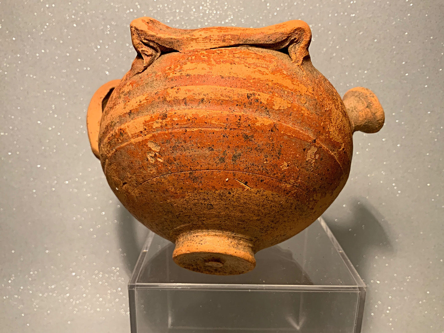 An ancient terracotta pot with spout