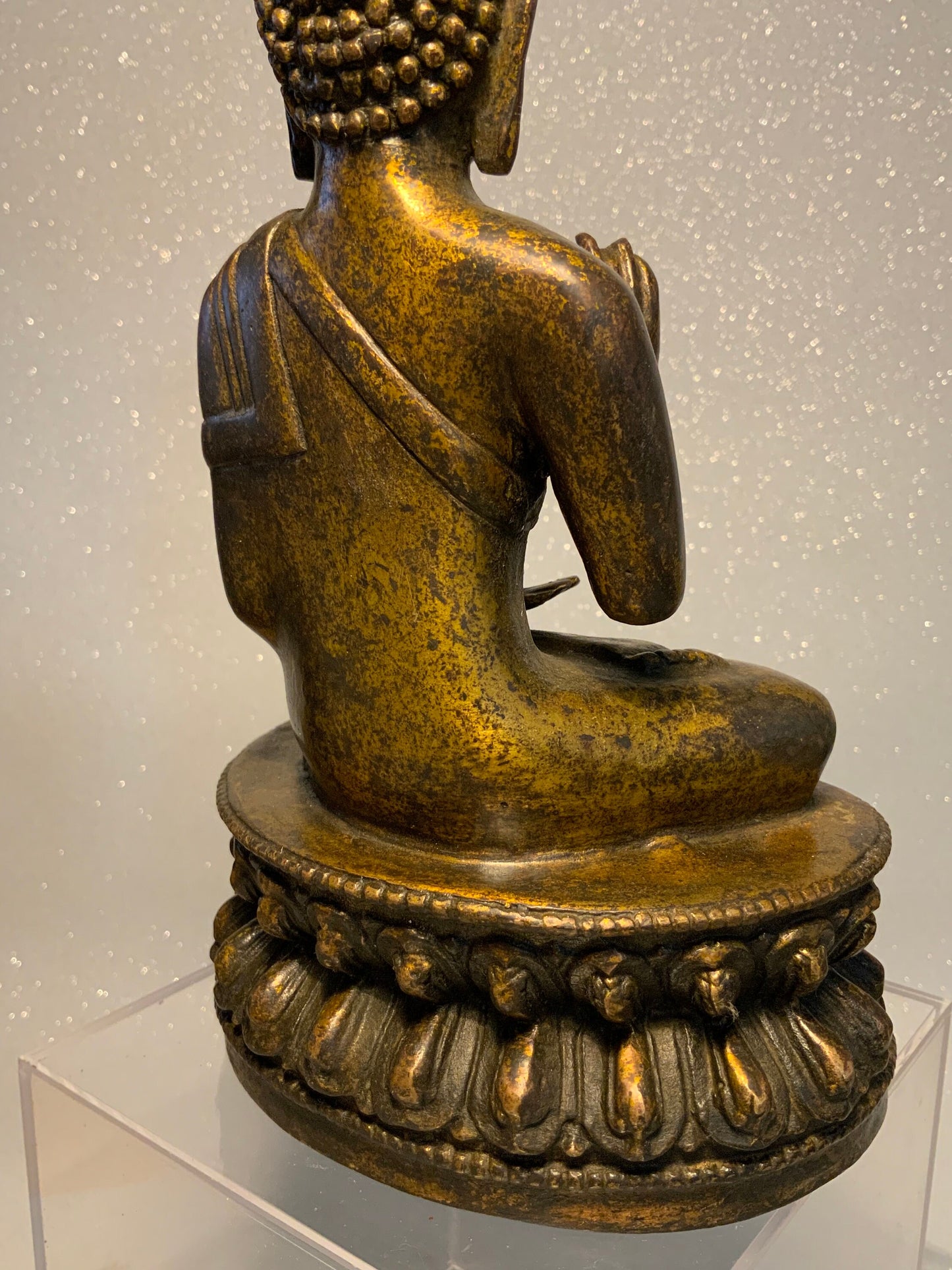An antique bronze and gilt Buddha statue