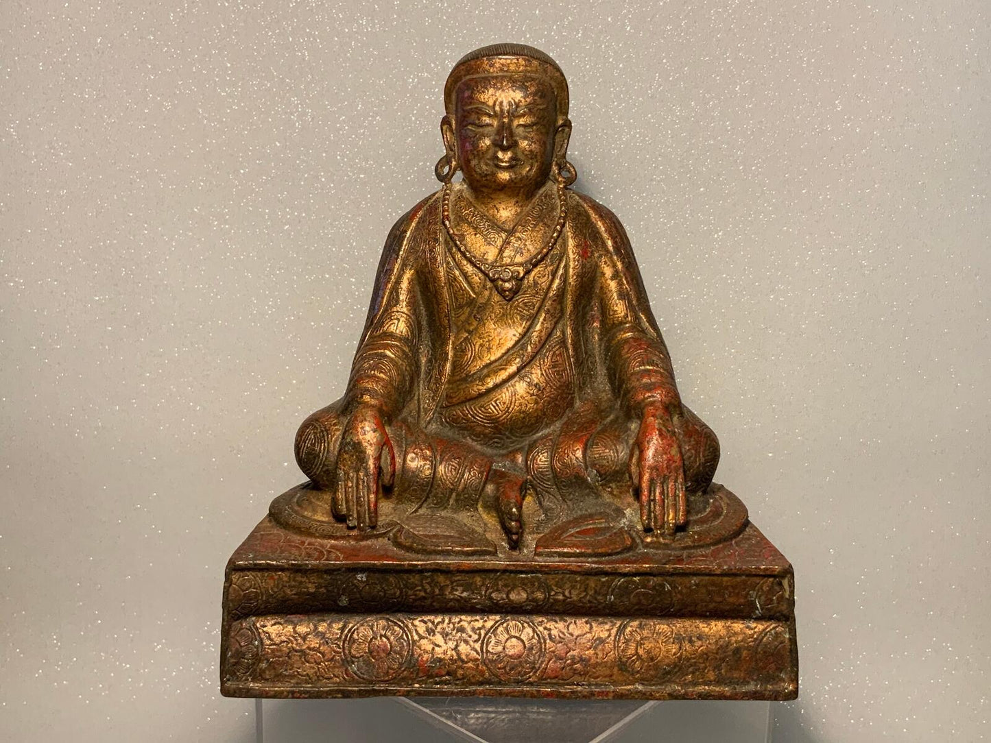 A antique bronze and gilt Buddha statue