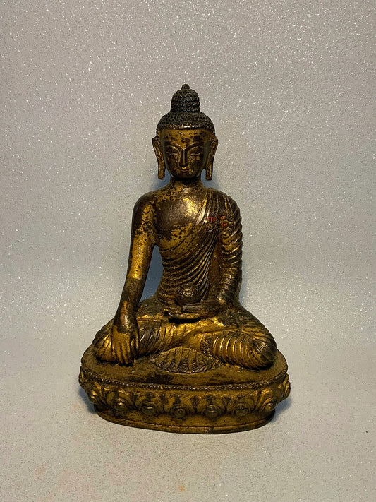 An  antique bronze and gilt Buddha statue