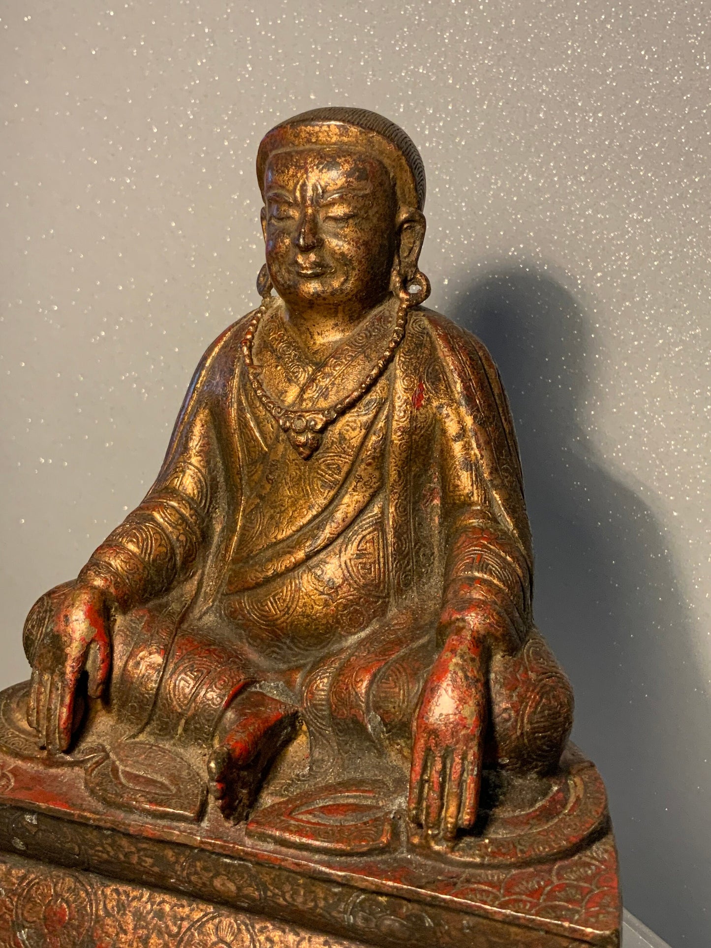 A antique bronze and gilt Buddha statue