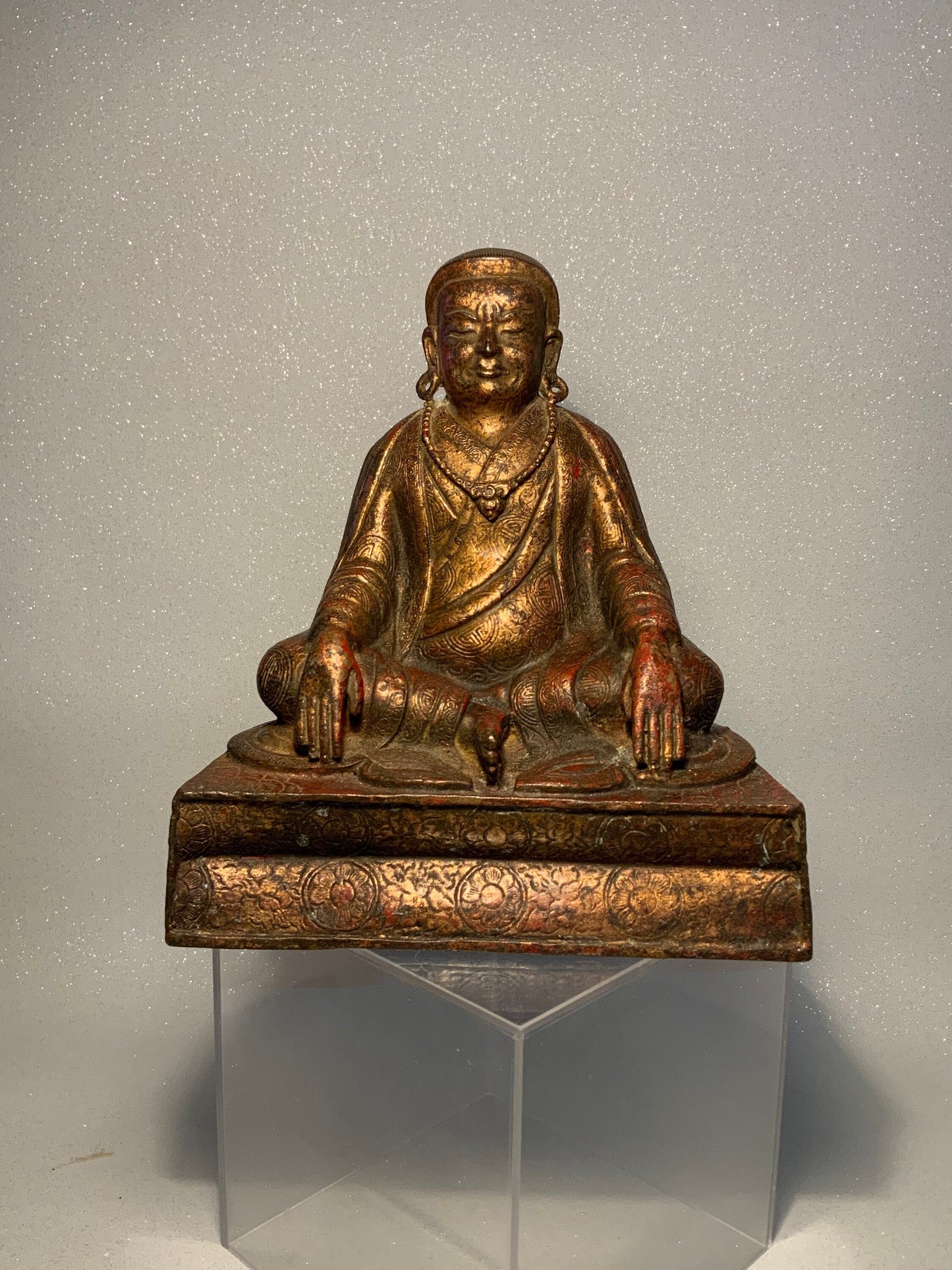 A antique bronze and gilt Buddha statue