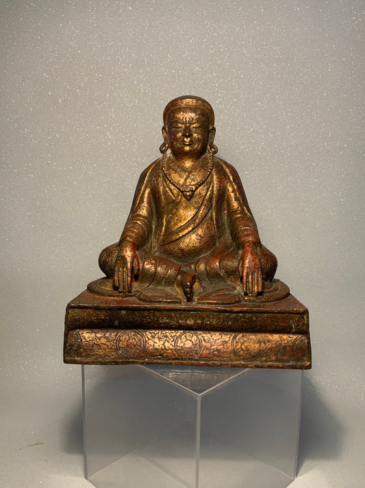 A antique bronze and gilt Buddha statue
