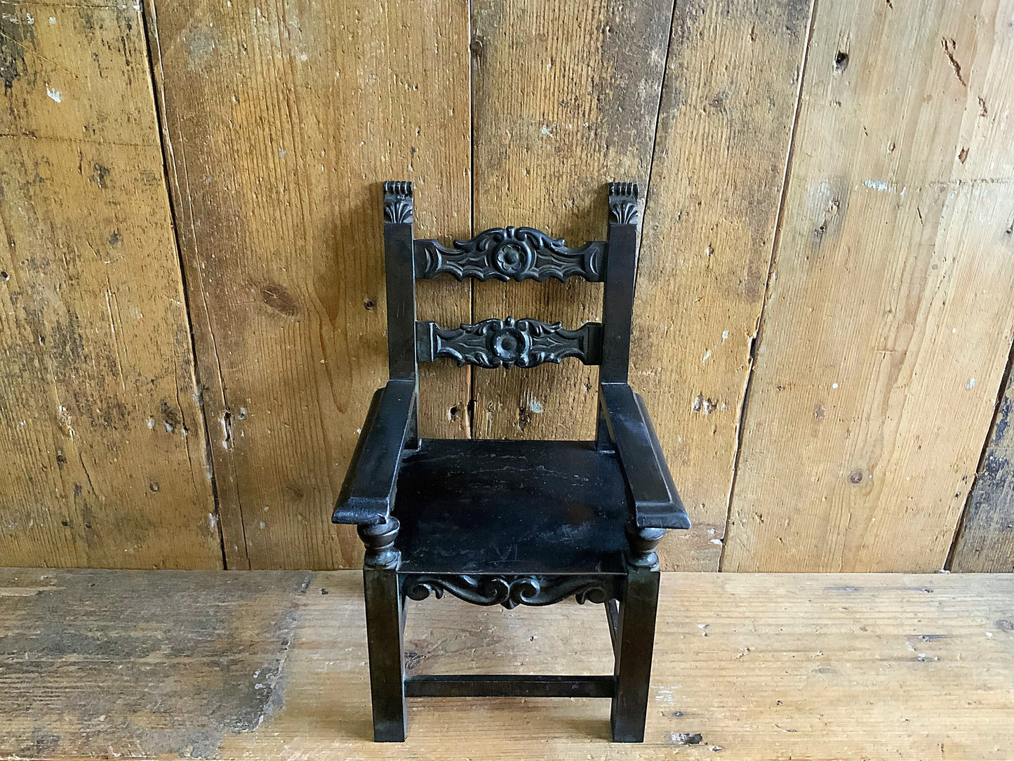 A stunning apprentice or salesman’s bronze thrown or chair