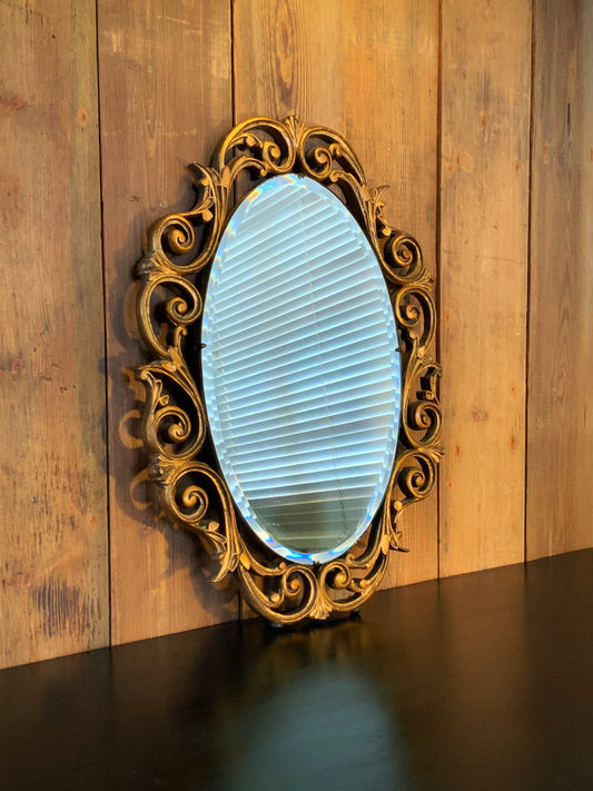 An outstanding gilt framed and bevelled oval  mirror